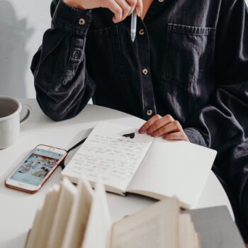 man writing in his happiness journal