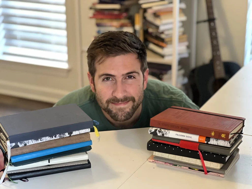 brooks with two stacks of journals